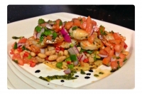 A light summer entree. Sautéed shrimp served over a white bean
salad and topped with homemade pico de gallo.