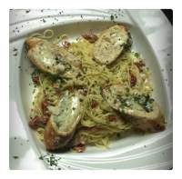Chicken Breast stuffed with Roasted Red Peppers, Spinach and
Cheese served over Capellini Pasta in a Pesto Cream Sauce.