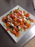 Crispy fried Calamari tossed in a Buffalo Wing sauce and served with a Bleu Cheese drizzle (or Ranch if you prefer).